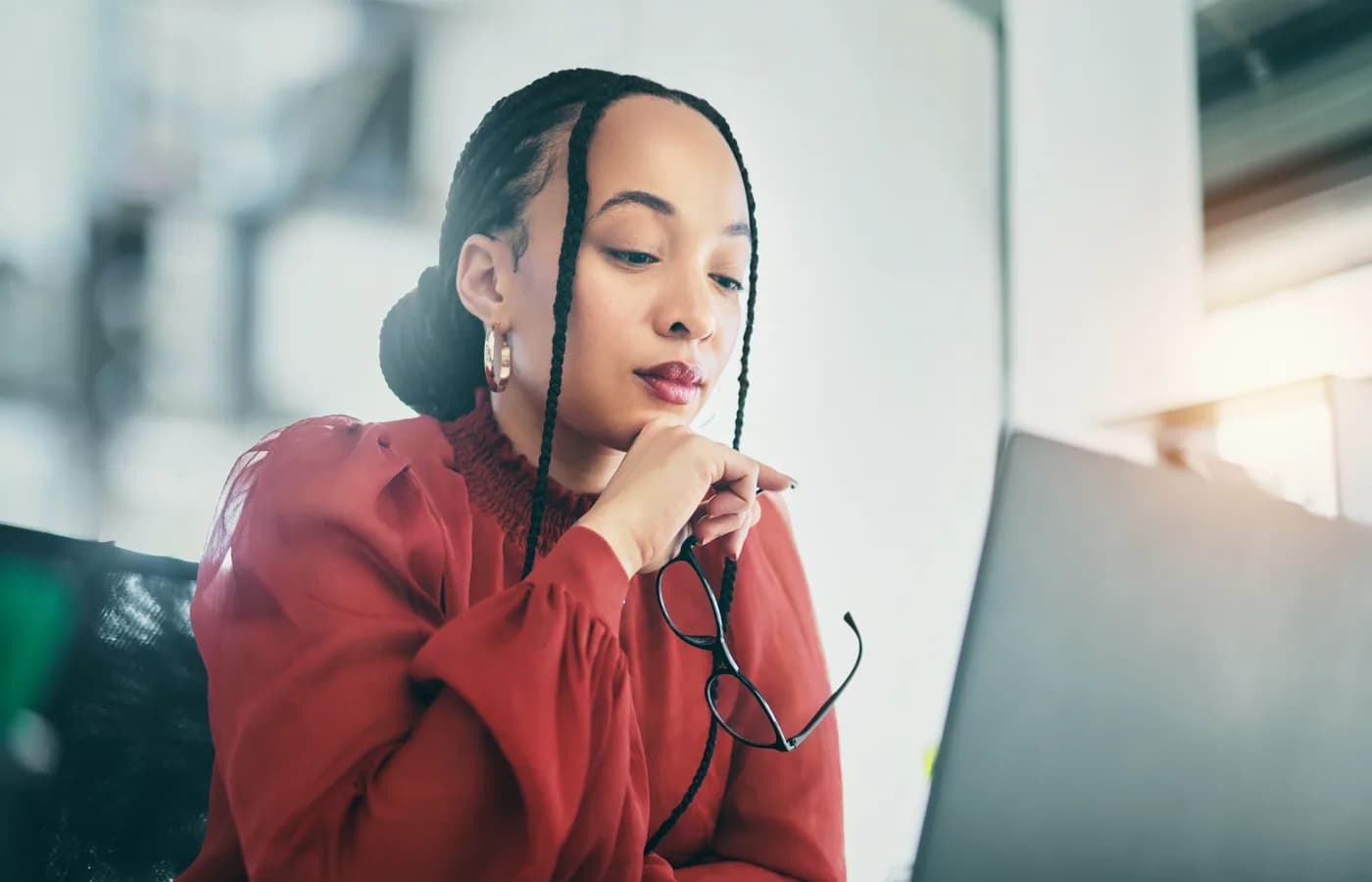 A professional working with a laptop and smartphone