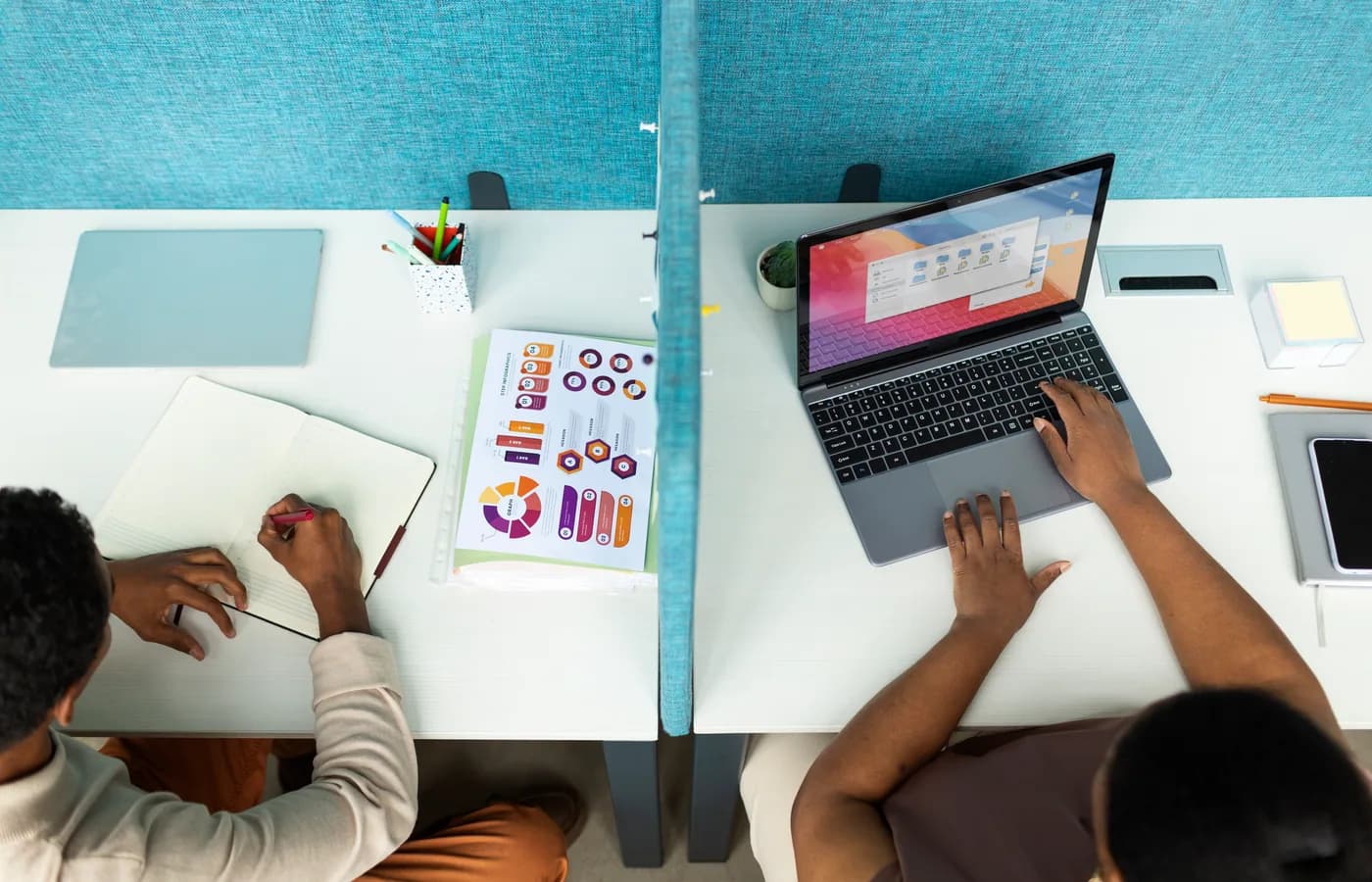 Creative professionals working across connected desks